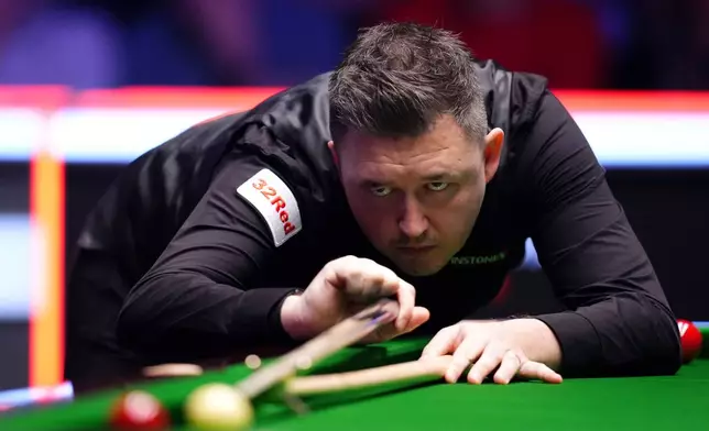 England's Kyren Wilson in action against Scotland's John Higgins during the final of the 2026 Masters Snooker at Alexandra Palace, London, Sunday Jan. 18, 2026. (John Walton/PA via AP)