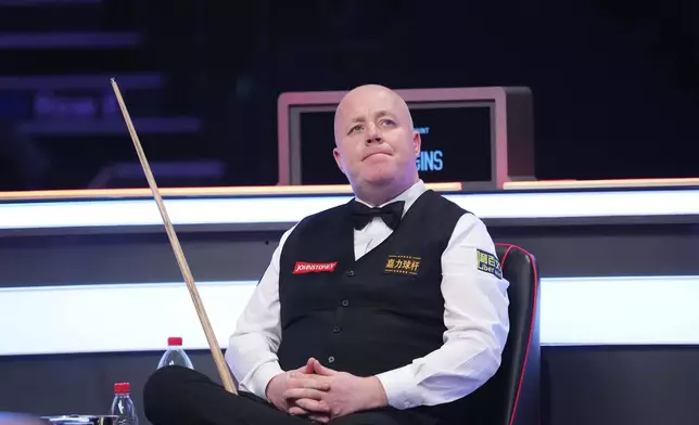Scotland's John Higgins in action against England's Judd Trump on day seven of the 2026 Masters Snooker at Alexandra Palace, London, Saturday Jan. 17, 2026. (Adam Davy/PA via AP)