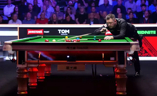 England's Kyren Wilson in action against Scotland's John Higgins during the final of the 2026 Masters Snooker at Alexandra Palace, London, Sunday Jan. 18, 2026. (John Walton/PA via AP)