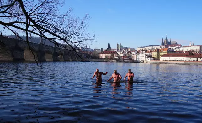 Polar swimmers take part in their traditional Three Kings swim in the Vltava River in Prague, Czech Republic, Tuesday, Jan. 6, 2026. (AP Photo/Petr David Josek)