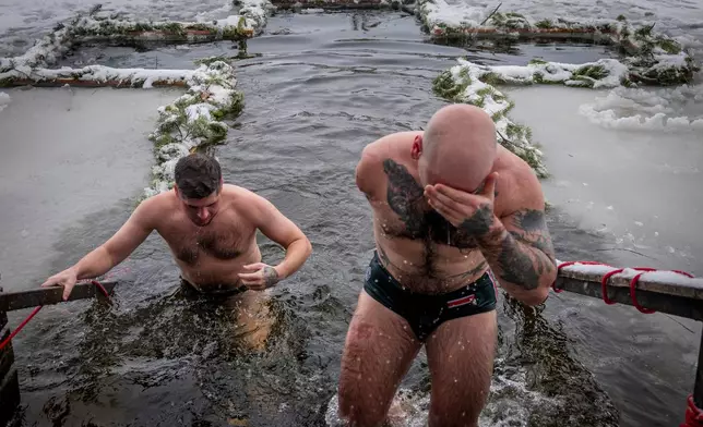 A veteran who lost his arm in Russia-Ukraine war, comes out of the icy water during celebrations of Epiphany in Kyiv, Ukraine, Tuesday, Jan. 6, 2026. (AP Photo/Dan Bashakov)