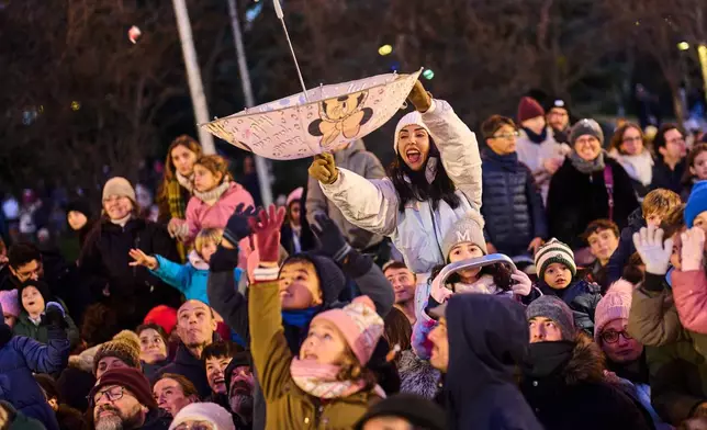 People attend the traditional "Cabalgata de Reyes" parade in Madrid, Spain, Monday, Jan. 5, 2026, as part of the festivities marking the Catholic feast of Epiphany. (AP Photo/Bernat Armangue)