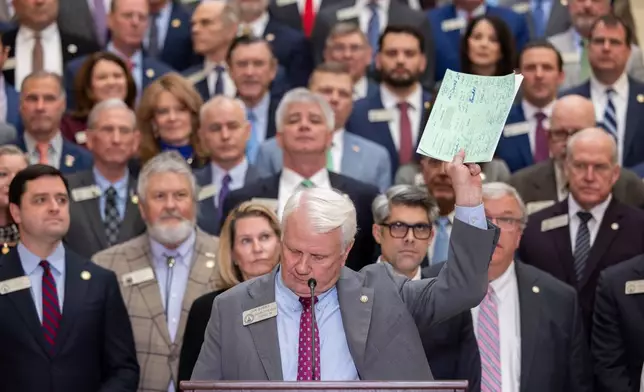House Speaker Jon Burns holds up proposed property tax relief legislation during a press conference at the Capitol in Atlanta on Wednesday, Jan. 28, 2026. (Arvin Temkar /Atlanta Journal-Constitution via AP)