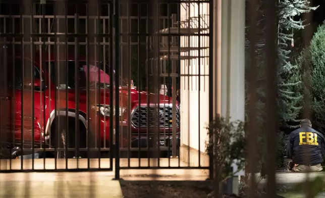The scene at Southeast 146th and East Burnside Street, where a red truck, shown here, ended up after reports that federal immigration officers shot and wounded people in Portland, Ore., Thursday, Jan. 8, 2026. (Beth Nakamura/The Oregonian via AP)
