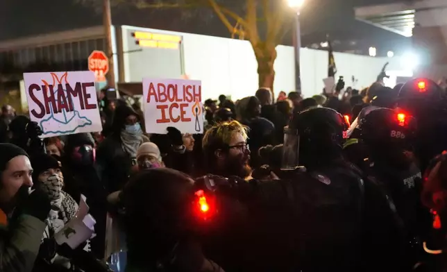 Protesters standoff against law enforcement outside the U.S. Immigration and Customs Enforcement facility on Thursday, Jan. 8, 2026, in Portland, Ore. (AP Photo/Jenny Kane)