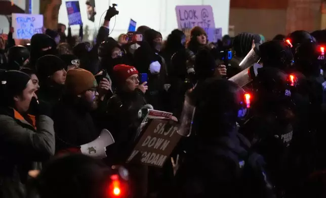Protesters standoff against law enforcement outside the U.S. Immigration and Customs Enforcement facility on Thursday, Jan. 8, 2026, in Portland, Ore. (AP Photo/Jenny Kane)