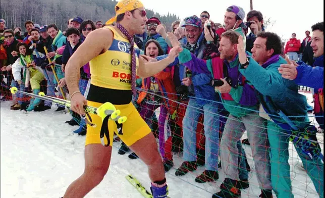 FILE - World Cup overall winner Alberto Tomba salutes his fans wearing shorts and a tie before the prize-giving ceremony in Bormio, Italy, March 19, 1995. (AP Photo/Alessandro Trovati, File)