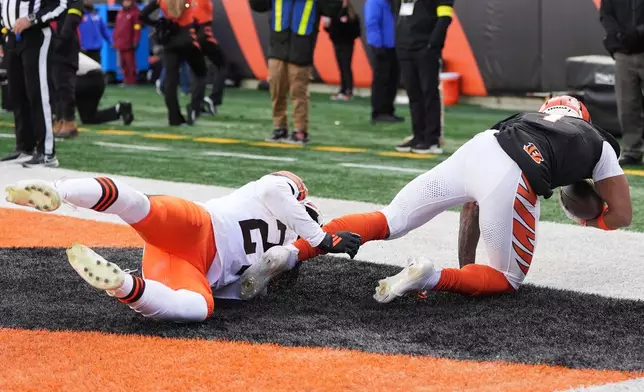 Cincinnati Bengals wide receiver Ja'Marr Chase, right, scores against Cleveland Browns cornerback Sam Webb during the second half of an NFL football game, Sunday, Jan. 4, 2026, in Cincinnati. (AP Photo/Joshua A. Bickel)