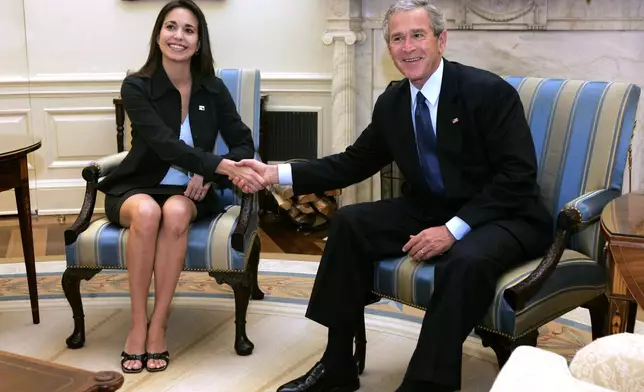 FILE - U.S. President George Bush, right, meets with Maria Corina Machado, executive director of Sumate, a non-governmental organization that defends Venezuelan citizens' political rights, in the Oval Office of the White House, Washington, May 31, 2005. (AP Photo/Charles Dharapak, File)
