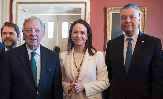 Venezuelan opposition leader Maria Corina Machado, center, is welcomed by Sen. Dick Durbin, D-Ill., left, Sen. Ruben Gallego, D-Ariz., far left, and Sen. Alex Padilla, D-Calif., right, as the Nobel Peace Prize recipient visits American leaders at the Capitol in Washington, Thursday, Jan. 15, 2026. (AP Photo/J. Scott Applewhite)