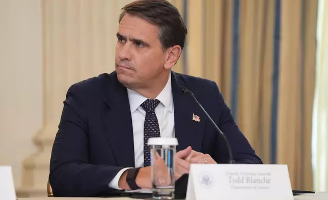 FILE - Deputy Attorney General Todd Blanche listens to President Donald Trump speak in the State Dining Room at the White House, Oct. 8, 2025, in Washington. (AP Photo/Evan Vucci, File)