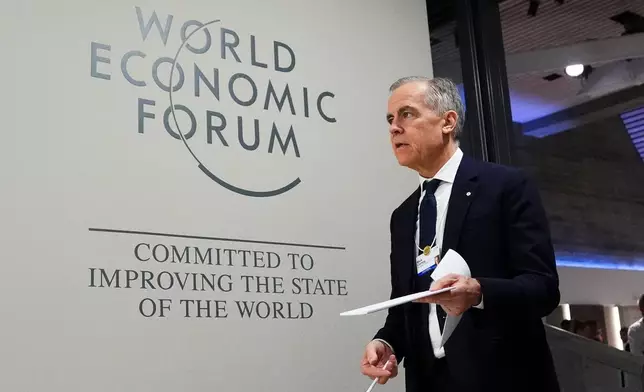 Canada Prime Minister Mark Carney makes his way to take part in an event tilted "Country Strategy Dialogue: Canada" as he attends the World Economic Forum in Davos, Switzerland on Tuesday, Jan. 20, 2026. (Sean Kilpatrick/The Canadian Press via AP)