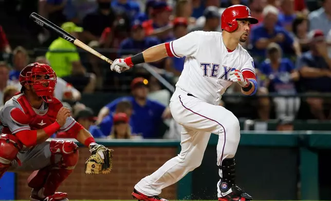 FILE - Texas Rangers' Carlos Beltran follows through on a two-run home run swing as Los Angeles Angels catcher Carlos Perez watches in the fifth inning of a baseball game, Sept. 21, 2016, in Arlington, Texas. (AP Photo/Tony Gutierrez, File)