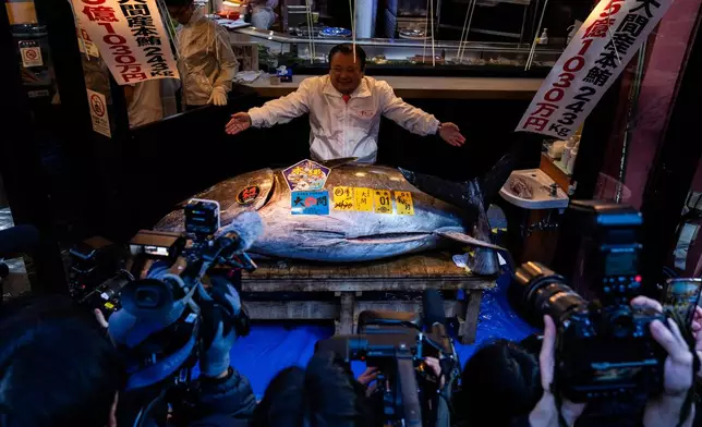 Kiyoshi Kimura, president of Kiyomura Co., poses with the bluefin tuna that won the highest bid at the annual New Year auction in Tokyo, Monday, Jan. 5, 2026. (AP Photo/Louise Delmotte)