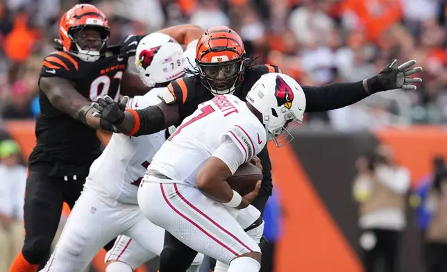 Cincinnati Bengals defensive tackle T.J. Slaton Jr. sacks Arizona Cardinals quarterback Jacoby Brissett during the second half of an NFL football game Sunday, Dec. 28, 2025, in Cincinnati. (AP Photo/Jeff Dean)
