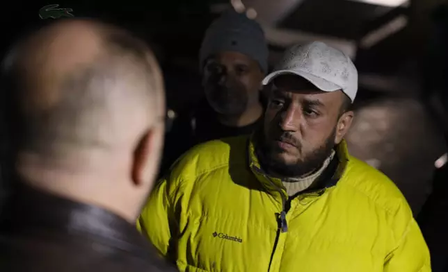 Ahmad Abu Sheikh, right, waits outside a hospital where his daughter, Fatima al-Zahra, 4, is receiving treatment after she was wounded when clashes broke out between Syrian government forces and Kurdish fighters in a contested area of the northern city of Aleppo, Syria, Tuesday, Jan. 6, 2026. (AP Photo/Omar Albam)
