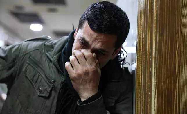 Syrian man Mohammed Ajam, weeps at a hospital after his son, Ghaith, 4, died after clashes broke out between Syrian government forces and Kurdish fighters in a contested area of the northern city of Aleppo, Syria, Tuesday, Jan. 6, 2026. (AP Photo/Omar Albam)