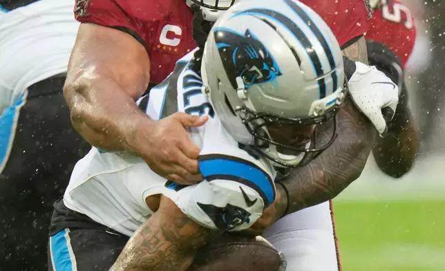Tampa Bay Buccaneers defensive tackle Vita Vea, top, tackles Carolina Panthers running back Rico Dowdle during the first half of an NFL football game Saturday, Jan. 3, 2026, in Tampa, Fla. (AP Photo/Chris O'Meara)