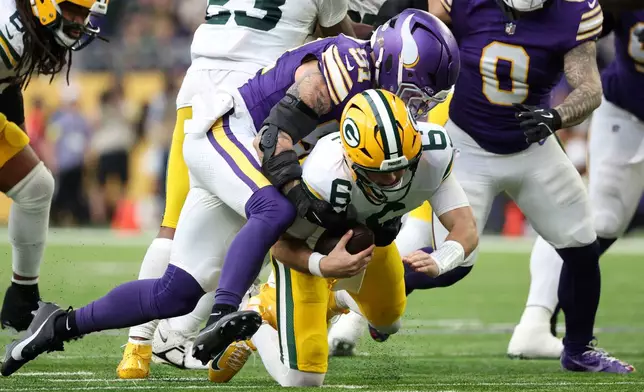 Minnesota Vikings linebacker Blake Cashman (51) sacks Green Bay Packers quarterback Clayton Tune (6) during the second half of an NFL football game, Sunday, Jan. 4, 2026, in Minneapolis. (AP Photo/Ellen Schmidt)