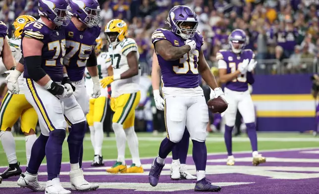 Minnesota Vikings fullback C.J. Ham (30) celebrates after a 1-yard touchdown run during the first half of an NFL football game against the Green Bay Packers, Sunday, Jan. 4, 2026, in Minneapolis. (AP Photo/Ellen Schmidt)