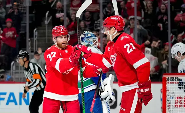 Detroit Red Wings left wing J.T. Compher, left, celebrates with left wing James van Riemsdyk, right, after scoring during the second period of an NHL hockey game against the Vancouver Canucks, Thursday, Jan. 8, 2026, in Detroit. (AP Photo/Ryan Sun)