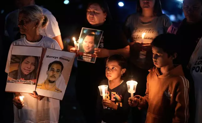 Relatives of people they consider political prisoners hold a vigil calling for the release of their loved ones outside the Rodeo I prison in Guatire, Venezuela, Friday, Jan. 23, 2026. (AP Photo/Ariana Cubillos)