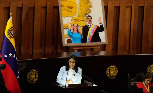 Venezuelan acting President Delcy Rodriguez speaks under a framed image of former President Nicolas Maduro and his wife Cilia Flores, during a ceremony marking the opening of the new judicial year at the Supreme Tribunal of Justice in Caracas, Venezuela, Friday, Jan. 30, 2026. (AP Photo/Ariana Cubillos)
