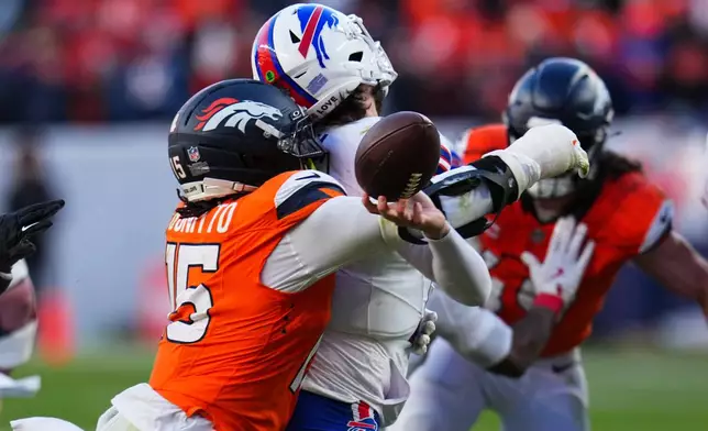 Buffalo Bills quarterback Josh Allen (17) fumbles the ball while being tackled by Denver Broncos linebacker Nik Bonitto (15) during the second half of an NFL divisional round playoff football game, Saturday, Jan. 17, 2026, in Denver. (AP Photo/Jack Dempsey)