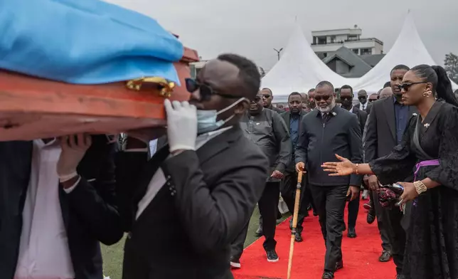 Corneille Nanga, coordinator of the AFC/M23, center, attends the funeral service for civilians killed in a drone strike in Goma, Democratic Republic of Congo, Thursday, Jan. 8, 2026. (AP Photo/Moses Sawasawa)
