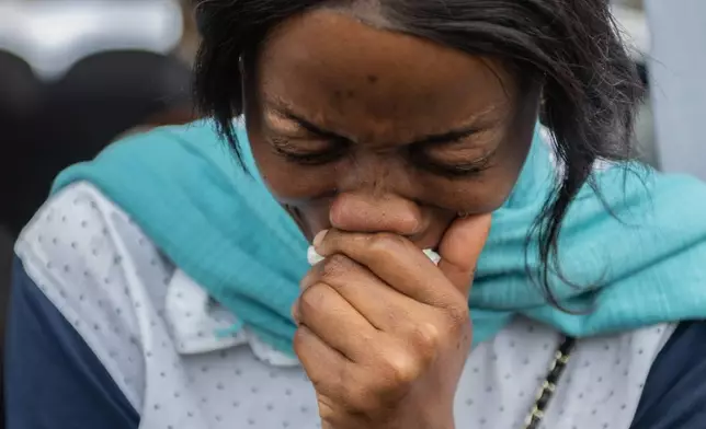 A woman mourns at the symbolic funeral service for civilians killed in a drone strike in Goma, Democratic Republic of Congo, Thursday, Jan. 8, 2026. (AP Photo/ Moses Sawasawa)