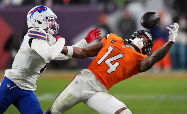Buffalo Bills cornerback Taron Johnson (7) is called for pass interference against Denver Broncos wide receiver Courtland Sutton (14) during overtime of an NFL divisional round playoff football game, Wednesday, Jan. 17, 2024, in Denver. (AP Photo/David Zalubowski)