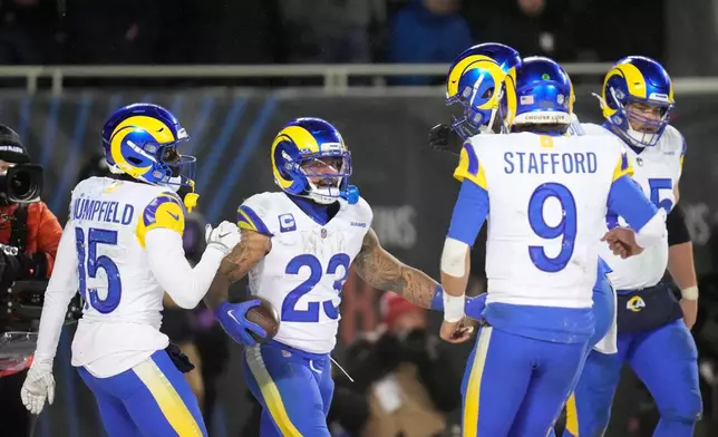 Los Angeles Rams running back Kyren Williams (23) celebrates his touchdown run with wide receiver Konata Mumpfield (15), quarterback Matthew Stafford (9), offensive tackle Warren McClendon Jr. back right, and center Coleman Shelton (65) during the second half of an NFL football divisional playoff game Sunday, Jan. 18, 2026, in Chicago. (AP Photo/Erin Hooley)