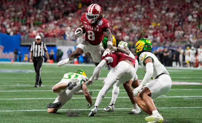 Indiana running back Kaelon Black (8) carries against Oregon during the first half of the Peach Bowl NCAA college football playoff semifinal, Friday, Jan. 9, 2026, in Atlanta. (AP Photo/Mike Stewart)