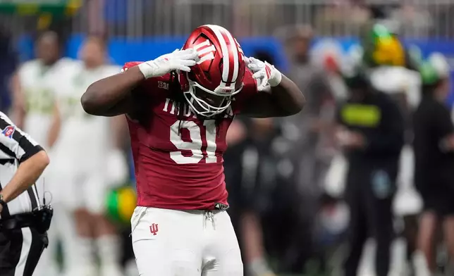 Indiana defensive lineman Dominique Ratcliff (91) celebrates his sack during the first half of the Peach Bowl NCAA college football playoff semifinal against Oregon, Friday, Jan. 9, 2026, in Atlanta. (AP Photo/Mike Stewart)
