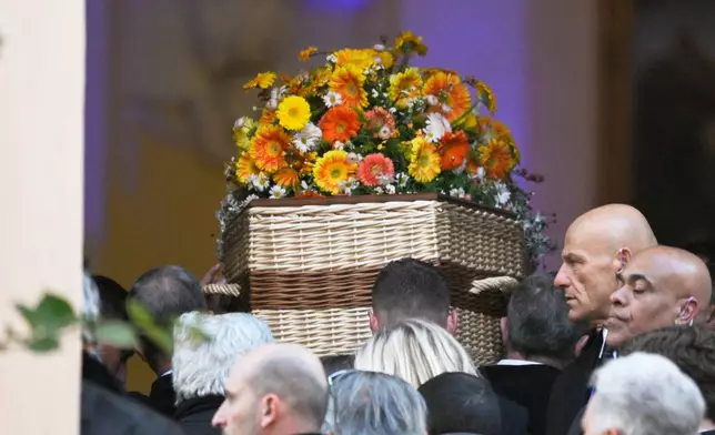 Actor Brigitte Bardot's coffin is carried into Notre-Dame de l'Assomption church for her funeral ceremony, Wednesday, Jan. 7, 2026 in Saint-Tropez, southern France. (AP Photo/Philippe Magoni)