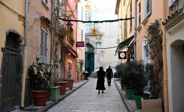 People walk in. Street leading to Notre-Dame de l'Assomption church before Brigitte Bardot's funeral ceremony, Wednesday, Jan. 7, 2026 in Saint-Tropez, southern France. (AP Photo/Philippe Magoni)