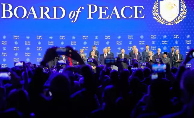 President Trump stands on the podium at the beginning a session on the Board of Peace initiative of US President Donald Trump at the Annual Meeting of the World Economic Forum in Davos, Switzerland, Thursday, Jan. 22, 2026. (AP Photo/Markus Schreiber)