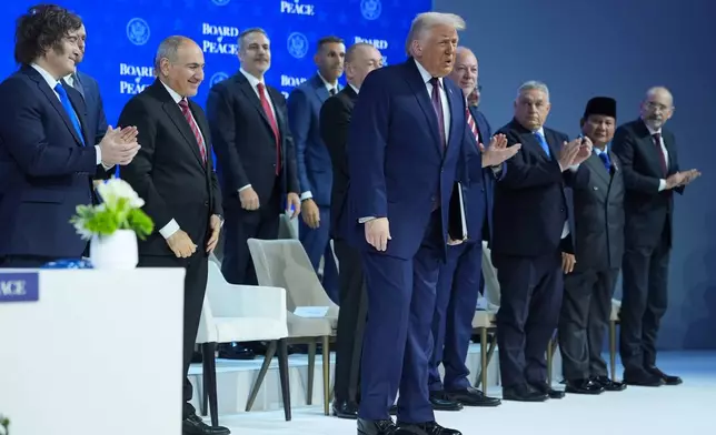 From right, Ayman Al Safadi, Deputy PM of of Jordan, Prabowo Subinato, President of Indonesia, Hungary's Prime Minister Viktor Orban, Bulgaria's Prime Minister Rossen Jeliazkov, Ilham Aliyev, President Donald Trump President of Azerbaijan, Turkish Foreign Minister Hakan Fidan, Nikol Pashinyan, Prime Minister of Armenia and Javier Milei, President of Argentina pose during a Board of Peace charter announcement during the Annual Meeting of the World Economic Forum in Davos, Switzerland, Thursday, Jan. 22, 2026. (AP Photo/Evan Vucci)