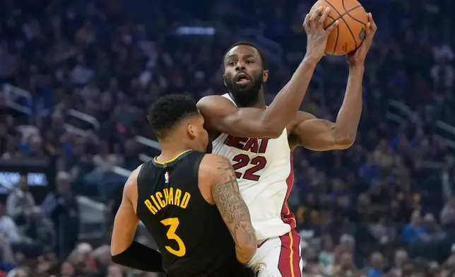 Miami Heat forward Andrew Wiggins (22) is fouled by Golden State Warriors guard Will Richard (3) before scoring on the play during the first half of an NBA basketball game in San Francisco, Monday, Jan. 19, 2026. (AP Photo/Jeff Chiu)