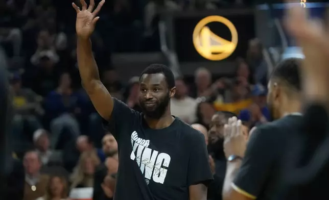 Miami Heat forward Andrew Wiggins waves to fans before an NBA basketball game against the Golden State Warriors in San Francisco, Monday, Jan. 19, 2026. (AP Photo/Jeff Chiu)