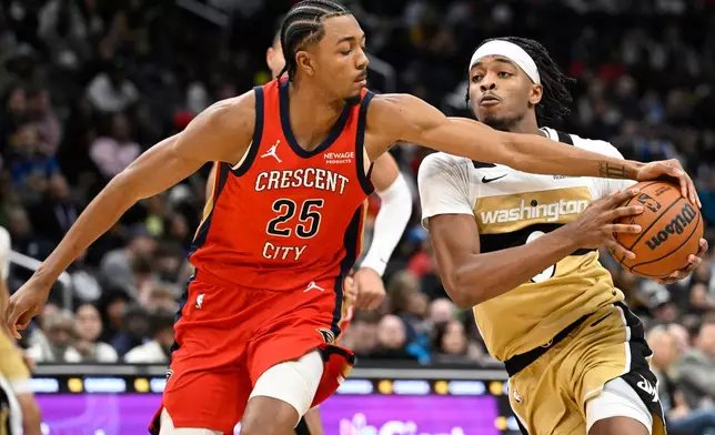 New Orleans Pelicans forward Trey Murphy III (25) guards against Washington Wizards guard Bilal Coulibaly, right, during the first half of an NBA basketball game, Friday, Jan. 9, 2026, in Washington. (AP Photo/John McDonnell)