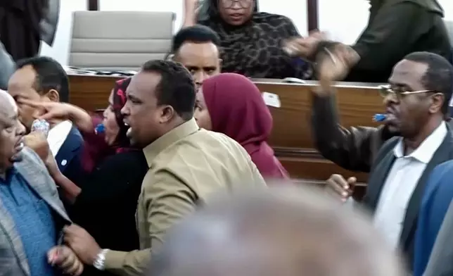 This image taken from an Associated Press video shows a scuffle between lawmakers during a joint session of Somalia's parliament Wednesday, Jan. 28, 2026, in Mogadishu, Somalia. (AP Photo/Mohamud Hassan)