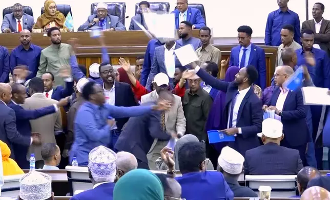 This image taken from an Associated Press video shows a scuffle between lawmakers during a joint session of Somalia's parliament Wednesday, Jan. 28, 2026, in Mogadishu, Somalia. (AP Photo/Mohamud Hassan)