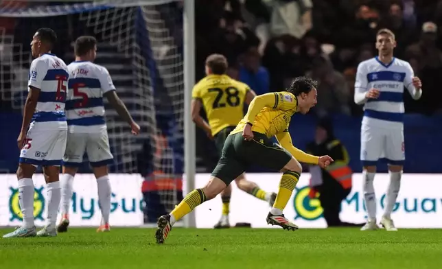 Wrexham's Ollie Rathbone, 2nd right, celebrates scoring their side's third goal of the game during the Sky Bet Championship soccer match between Queens Park Rangers and Wrexham in London, Saturday Jan. 24, 2026. (Ben Whitley/PA via AP)