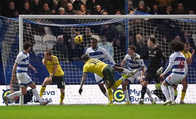 Wrexham's Josh Windass, third left, scores their side's second goal of the game during the Sky Bet Championship soccer match between Queens Park Rangers and Wrexham in London, Saturday Jan. 24, 2026. (Ben Whitley/PA via AP)