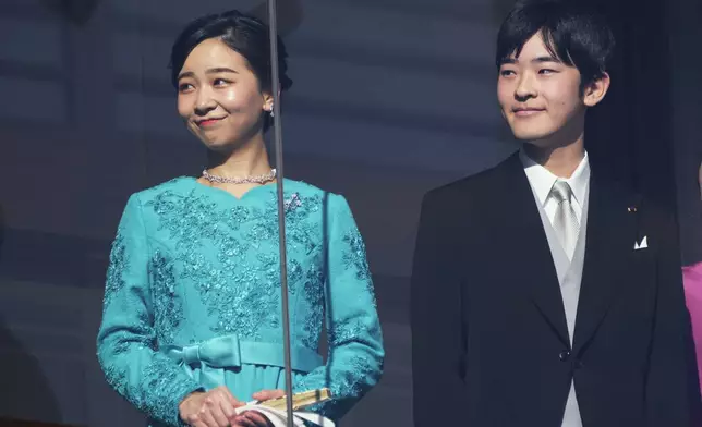 Japan's Princess Kako and Prince Hisahito, daughter and son of Crown Prince Akishino and Crown Princess Kiko, greet well-wishers during a public appearance for New Year's celebrations at the Imperial Palace in Tokyo, Friday, Jan. 2, 2026. (AP Photo/Eugene Hoshiko)