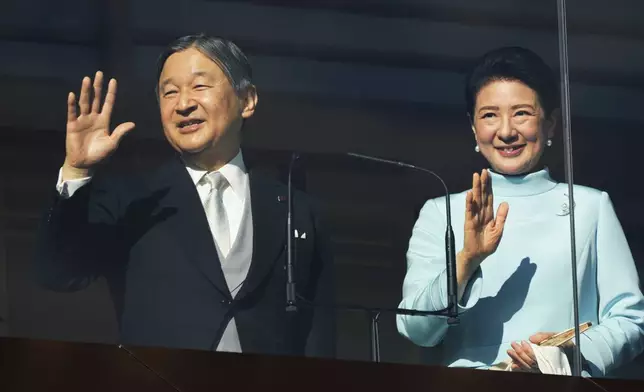 Japan's Emperor Naruhito and Empress Masako greet well-wishers during a public appearance for New Year's celebrations at the Imperial Palace in Tokyo, Friday, Jan. 2, 2026. (AP Photo/Eugene Hoshiko)