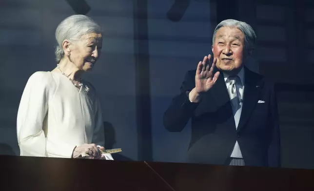 Japan's Emperor Emeritus Akihito and Empress Emerita Michiko greet well-wishers during a public appearance for New Year's celebrations at the Imperial Palace in Tokyo, Friday, Jan. 2, 2026. (AP Photo/Eugene Hoshiko)