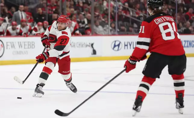 Carolina Hurricanes left wing Nikolaj Ehlers (27) takes a shot in the first period of an NHL hockey game against the New Jersey Devils, Sunday, Jan. 4, 2026, in Newark, N.J. (AP Photo/Heather Khalifa)