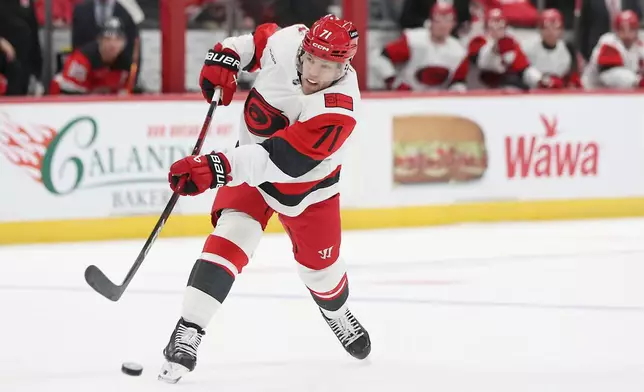 Carolina Hurricanes left wing Taylor Hall takes a shot in the first period of an NHL hockey game against the New Jersey Devils, Sunday, Jan. 4, 2026, in Newark, N.J. (AP Photo/Heather Khalifa)